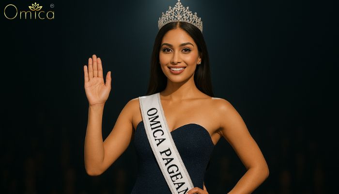 Indian beauty queen wearing a crown and sash on stage at Omica Pageant, representing confidence, grace, and judging criteria.