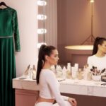 AI-Generated pageant contestant preparing in a makeup studio with skincare products, vanity mirror, and evening gown in the background
